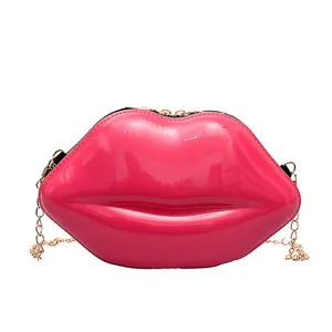 Chic lip-shaped mini crossbody bag in magenta patent leather with a gold chain strap