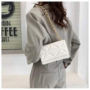 Chic cream crossbody bag featuring 3D triangle quilting and chunky gold chain strap