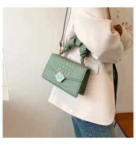 Mint green crocodile embossed small square bag with pleated handle and metal buckle