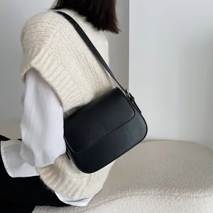 Minimalist black PU leather saddle bag with adjustable shoulder strap for women