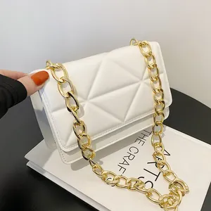 White quilted faux leather crossbody bag with chunky gold chain strap and flap closure