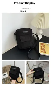 Detail view of black corduroy crossbody bag with flap pocket and nylon shoulder strap