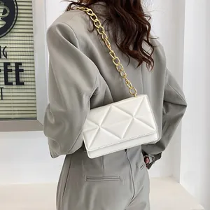 Chic white quilted crossbody flap bag with a bold gold chain strap for women