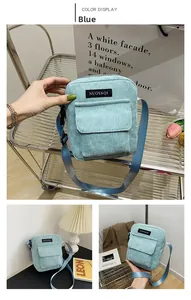 Detailed view of sky blue corduroy crossbody bag with adjustable wide strap and front pocket