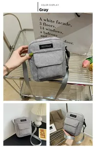 Detail view of a gray corduroy shoulder bag showing the fabric texture and logo label
