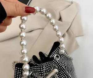 Detailed macro view of the pearl-beaded handle and silver rhinestone-encrusted bucket bag