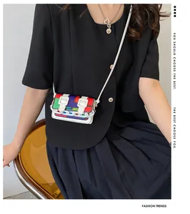 Close-up of vibrant color-block mini bag with white chain and needle buckle detail