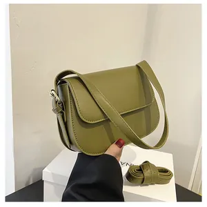 Detail view of olive green matte leather saddle bag with interchangeable straps