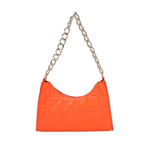 Vibrant orange quilted underarm bag with gold chain strap in a stylish square design