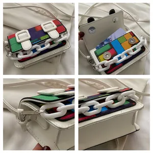 Macro detail of mini crossbody bag with colorful mosaic pattern and card slot interior