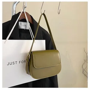 Detailed view of an olive green matte saddle bag featuring a gold buckle and adjustable strap