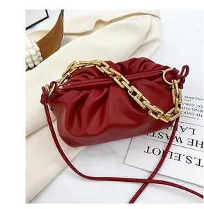 Deep burgundy cloud bag with chunky gold chain handle and soft pleated leather texture