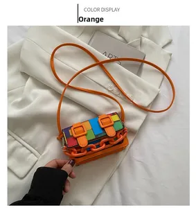 Detailed close-up of a mini orange crossbody bag featuring colorful mosaic color-blocking
