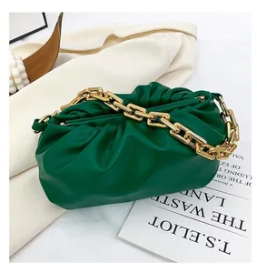Detailed view of the dark green cloud bag featuring pleated faux leather and gold chain