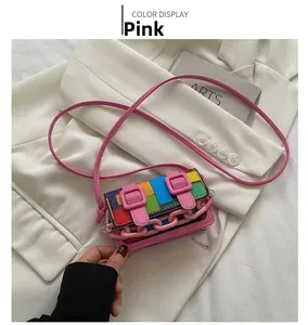 Detail of a mini mosaic crossbody bag with pink resin chain and belt buckle accents