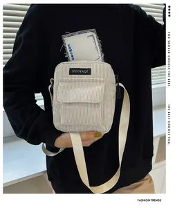 Detail of cream corduroy shoulder bag showing vertical texture and NUOYAQI logo tag