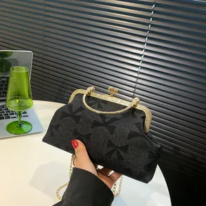 Elegant black bow-textured jacquard evening clutch with gold metal handle and chain