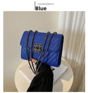 Detail of blue pebble leather bag featuring V-shaped quilting and a retro metal lock