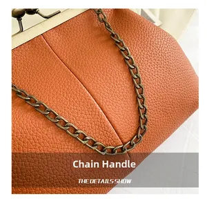 Close-up of caramel shell bag featuring lychee texture leather and chain handle