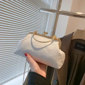 Elegant white satin evening bag with ribbon bow texture and gold circular handle
