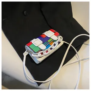 Detail of colorful geometric flap mini crossbody bag with white decorative chains