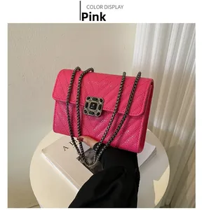 Close-up of rose pink crossbody bag featuring V-quilted texture and vintage metal lock