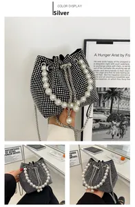 Detail showing shimmering silver rhinestones and elegant faux pearl handle on a bucket bag