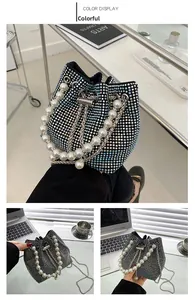 Detail of multicolor rhinestone bucket bag with pearl handle and silver chain strap