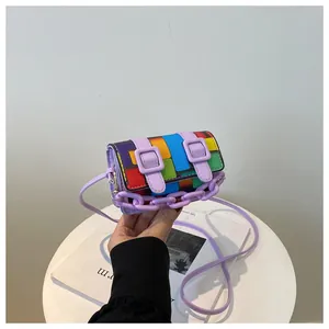 Detailed close-up of a mini rainbow patchwork crossbody bag with purple chunky chain strap