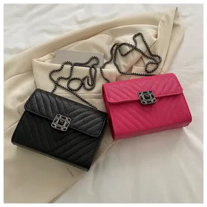 Flat lay view of small square bags in black and rose red with V-quilted faux leather