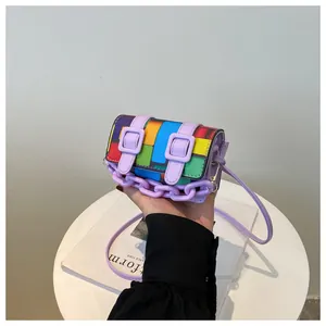 Detailed close-up of a mini crossbody bag with colorful mosaic blocks and purple chain