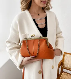 Orange shell-shaped handbag with litchi texture and retro bronze kiss-lock closure