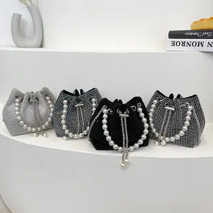 Detail view of pearl handle bucket bags in silver, blue, black, and polka dot rhinestone