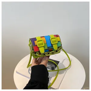 Detailed view of colorful geometric mosaic crossbody bag with neon green plastic chain