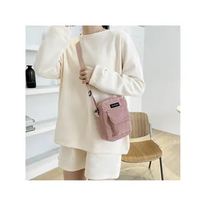 Pink corduroy crossbody bag for women with adjustable strap in minimalist casual style