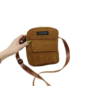 Caramel brown corduroy crossbody bag with adjustable strap and front flap pocket