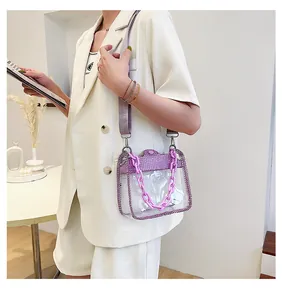 Detail of transparent PVC mini bag with purple rhinestones and acrylic chain strap