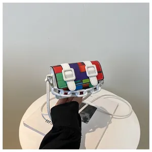 Detailed view of mini geometric mosaic crossbody bag with colorful panels and white chains
