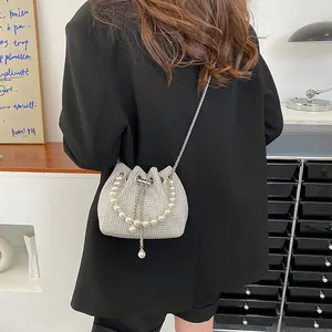 Elegant silver rhinestone drawstring bucket bag with pearl handle and metal chain strap