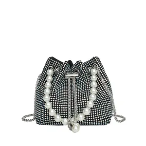 Sparkling rhinestone bucket bag with large pearl handle and silver chain strap