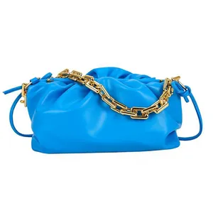 Fashionable sky blue pleated cloud bag with chunky gold chain strap on white background