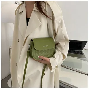Green leather crossbody saddle bag with diamond texture and fashion slogan print