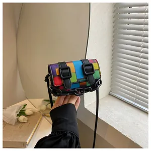 Detail of mini square crossbody bag with color-block pattern and black chain strap