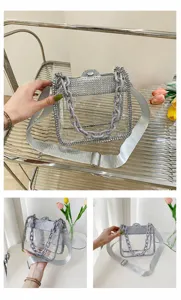 Detailed macro view of the silver rhinestone edges and thick purple chain on mini bag