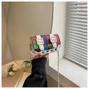 Detail view of mini multi-color geometric crossbody bag with white resin chain