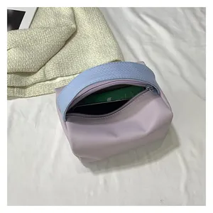 Detail of lavender PU leather mini bag with blue woven handle and silver metal zipper