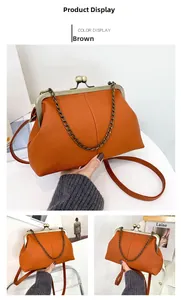 Detail view of brown lychee pattern shell bag with vintage gold metal chain and clasp