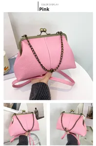 Detailed macro view of pink litchi grain leather texture and vintage metal clasp closure