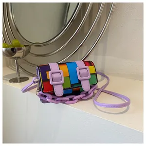 Detail of colorful pixel pattern mini bag with purple plastic chain and leather strap