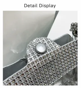 Close-up of sparkling rhinestone handbag featuring a sleek silver round metal clasp